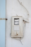 A technician inspecting a modern electrical meter on a residential home.