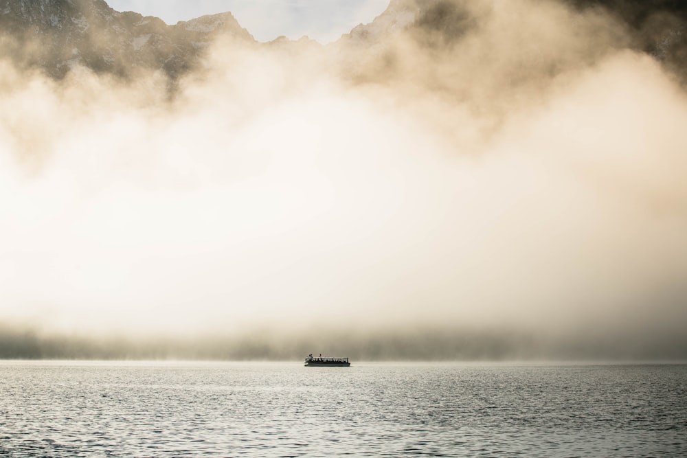 passenger boat under white clouds during daytime