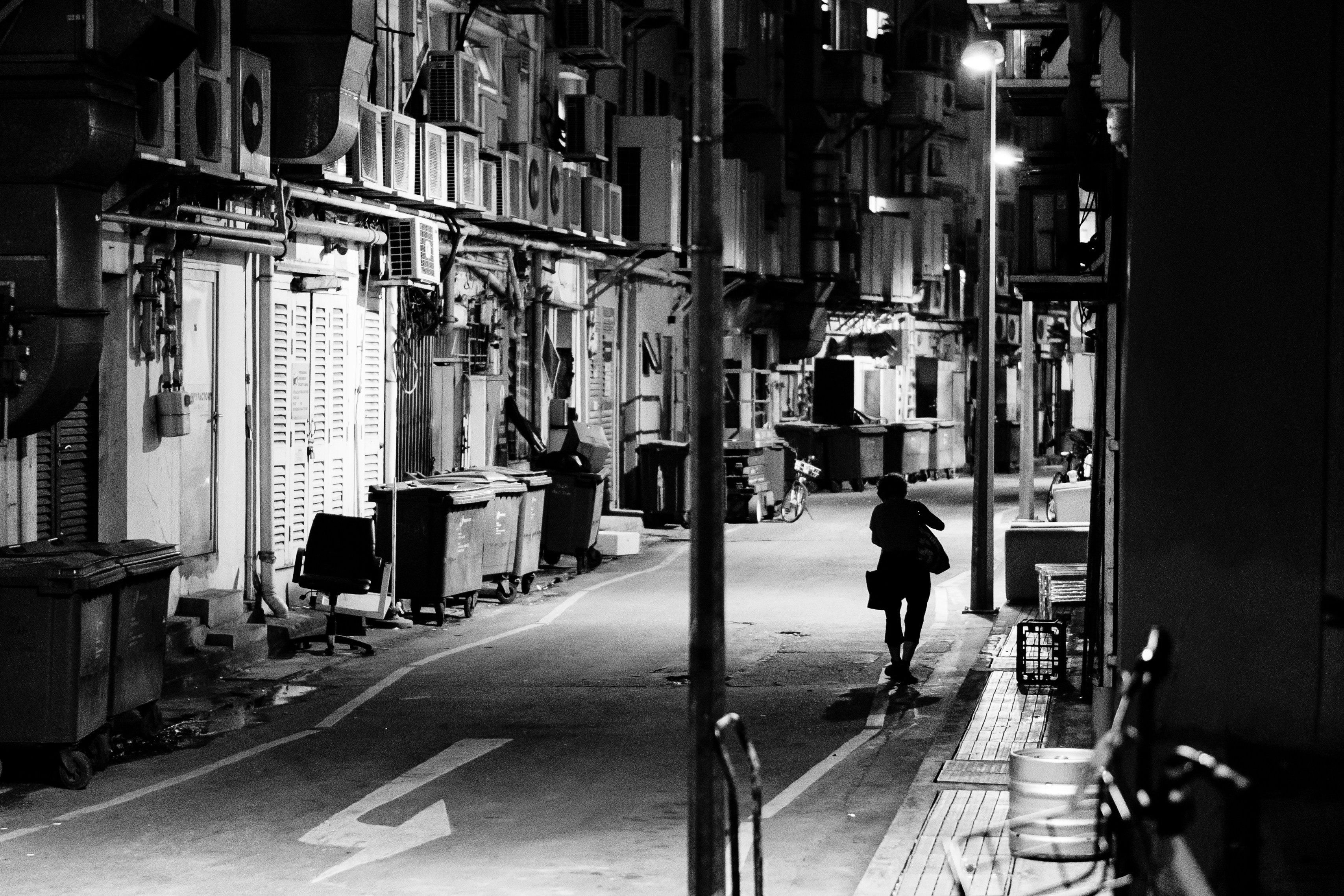 grayscale photo of person walking on street