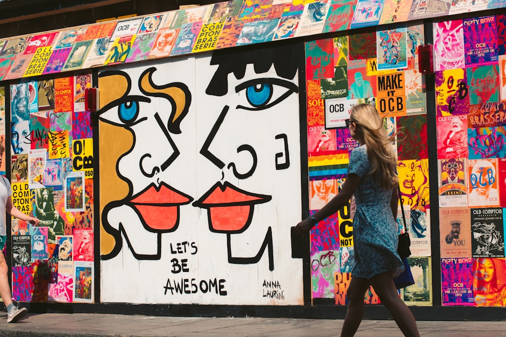 woman walking passes graffiti