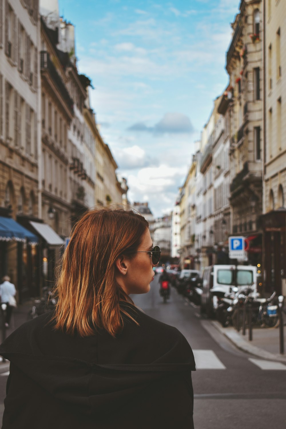 woman standing on gray road