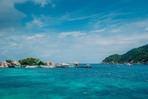 A peaceful seaside property with a private dock and turquoise waters.