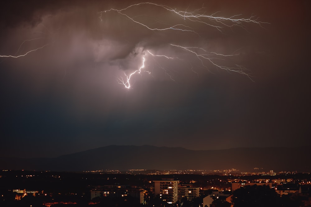 lightning strike over the city during night time