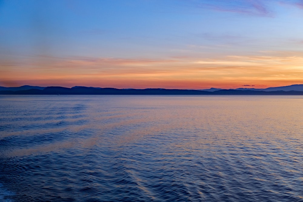 calm body of water during golden hour