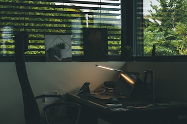 black rolling armchair near brown wooden desk