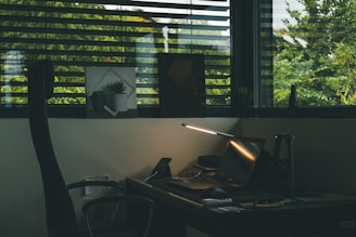 black rolling armchair near brown wooden desk