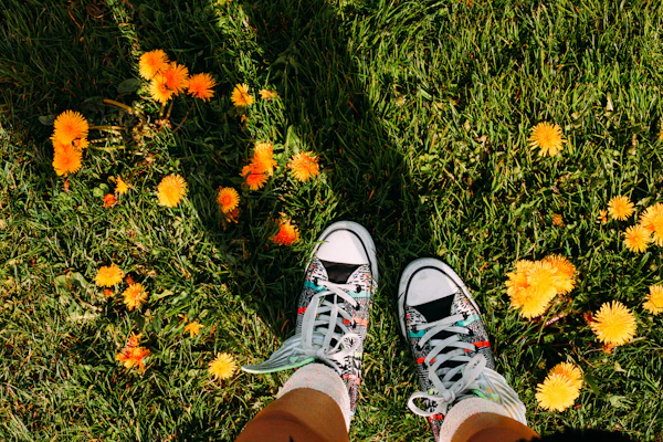 Bright sneakers in playful colors worn by a smiling child running in a sunny park.