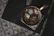 Close-up of a hammered copper mug filled with a refreshing beverage, glistening under soft light.