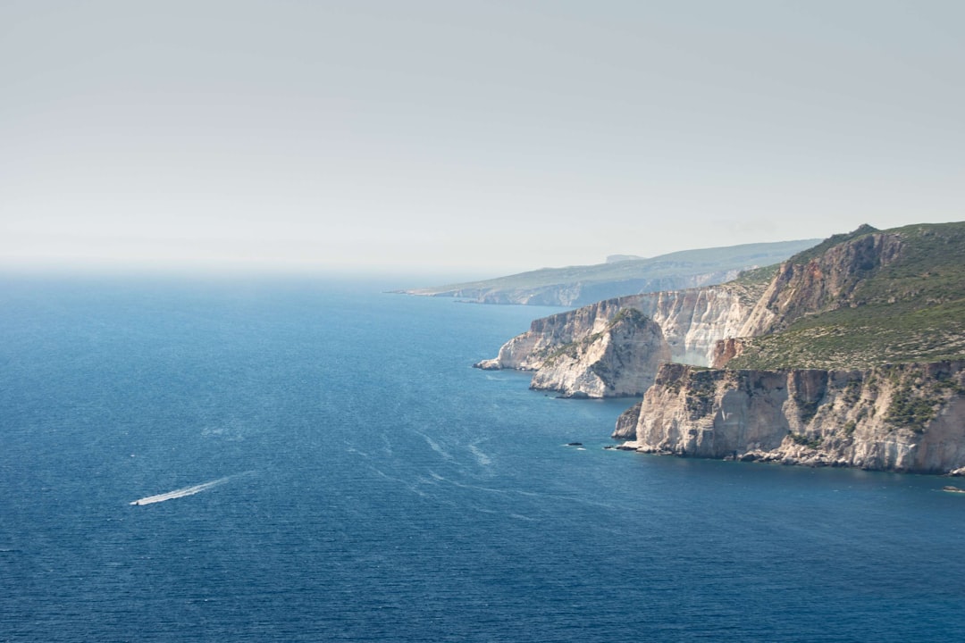 aerial photography of body of water and mountain