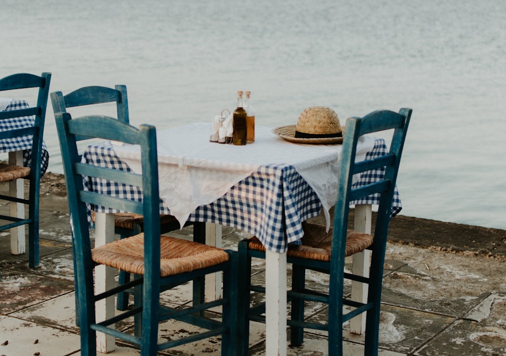 brown sun hat on top of table near calm water