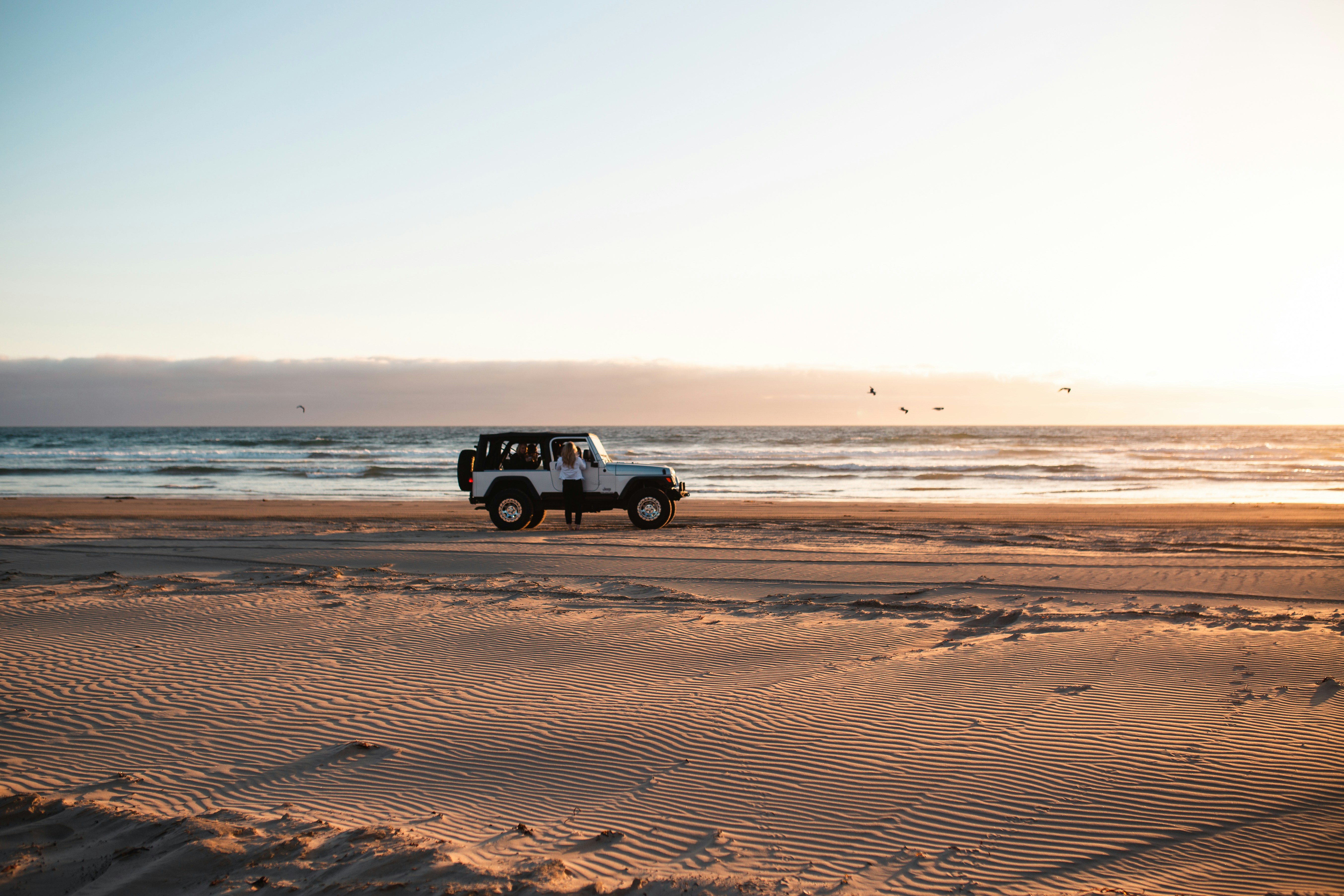 white wrangler beside the beach