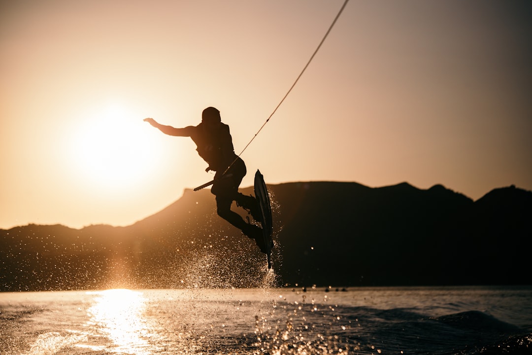 person wake boarding on body of water, Wakeboarding at Sunset
