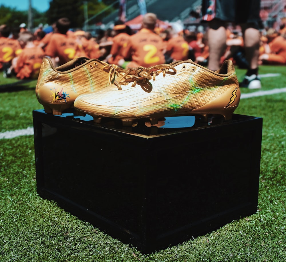pair of brown cleats on box