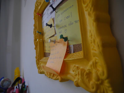 Close-up of a premium fabric notice board framed in sleek aluminium, displaying colorful notes.