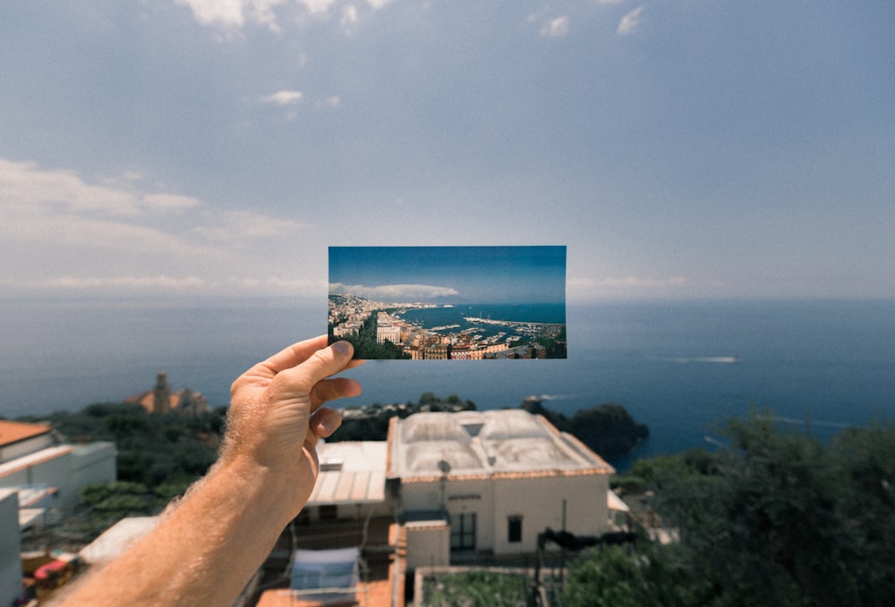 person holding photo of a city