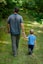 man in gray polo shirt and gray pants holding child in blue shirt