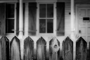Side-by-side photos showing an old weathered fence replaced by a new, sturdy privacy fence.