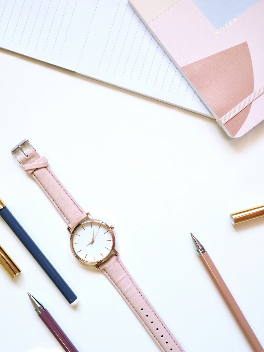 round gold-colored analog watch