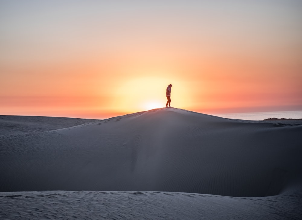 man standing on mountain peak