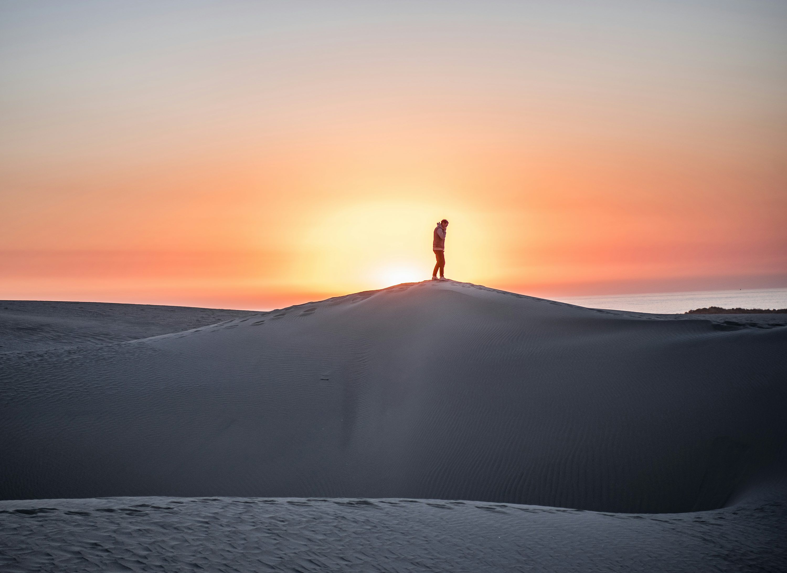 man standing on mountain peak