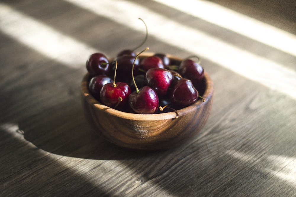 bunch of red cherries in brown bowl