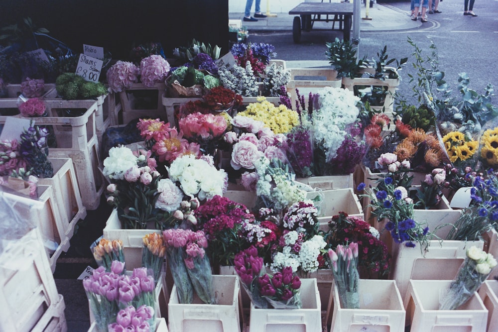 assorted flowers in brown flower boxes