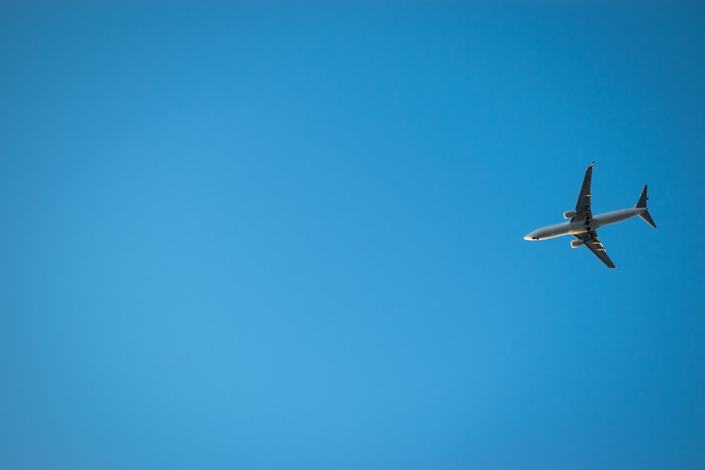 flying white airplane