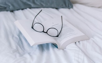 black framed eyeglasses on book page