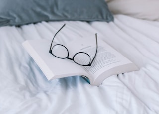 black framed eyeglasses on book page