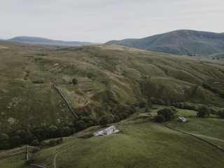 A scenic countryside estate surrounded by rolling hills and greenery.