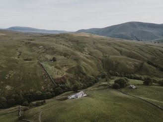 Spacious countryside farmhouse surrounded by rolling green fields.