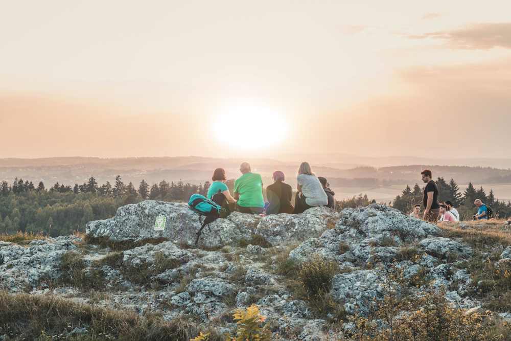 people sitting watching sun rise