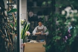 woman standing beside the table
