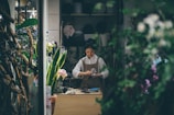 woman standing beside the table
