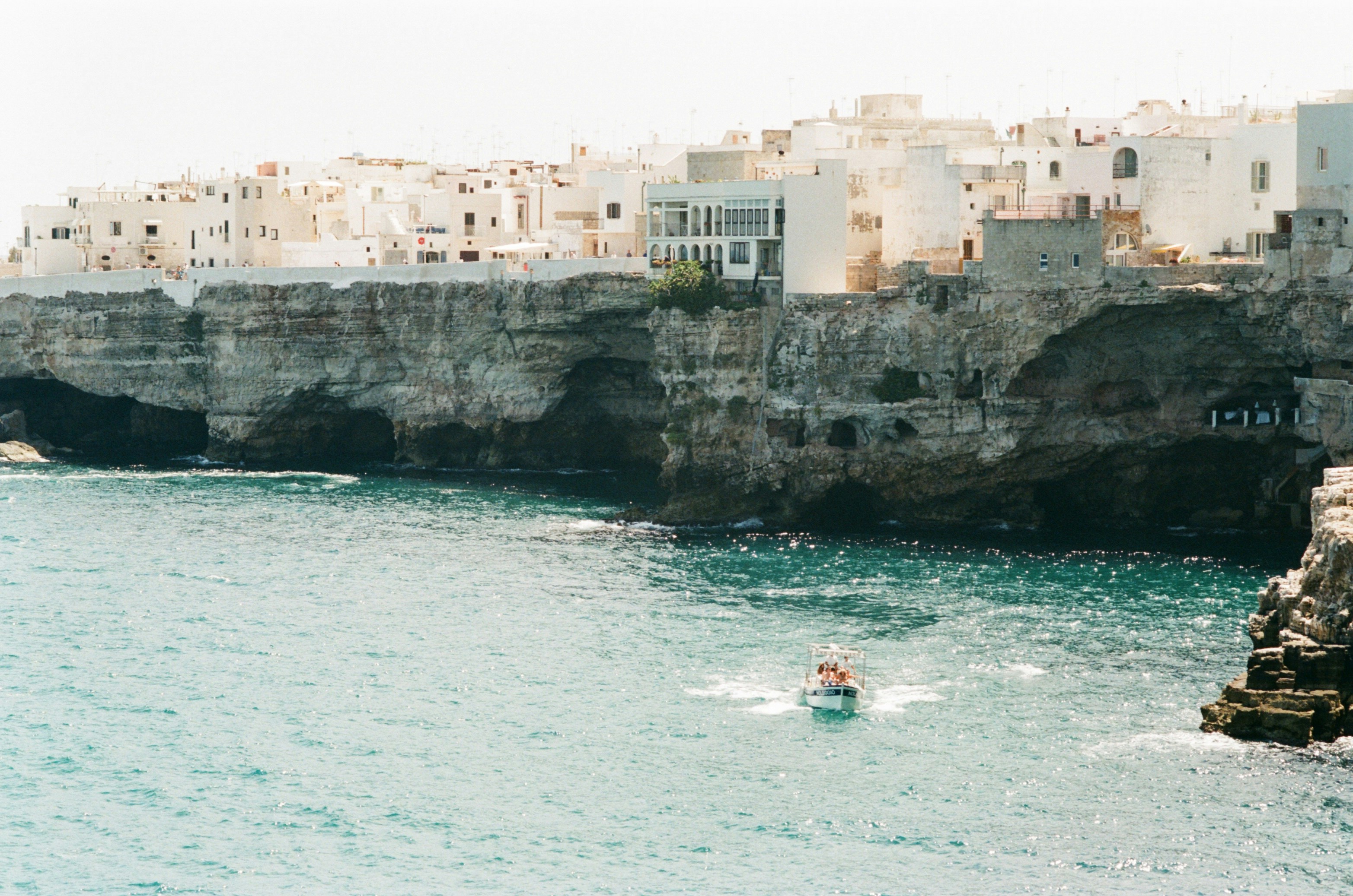 //Shot on expired Kodak Gold Film While developing the film, I asked the lab to push a bit the film to give this golden hour feel to the water and to separate the white houses from the sky. They remind of Greece, don’t they? But this is the south east of Italy in the Puglia region. A part of Italy forgotten by time, and by the rest of the country…
