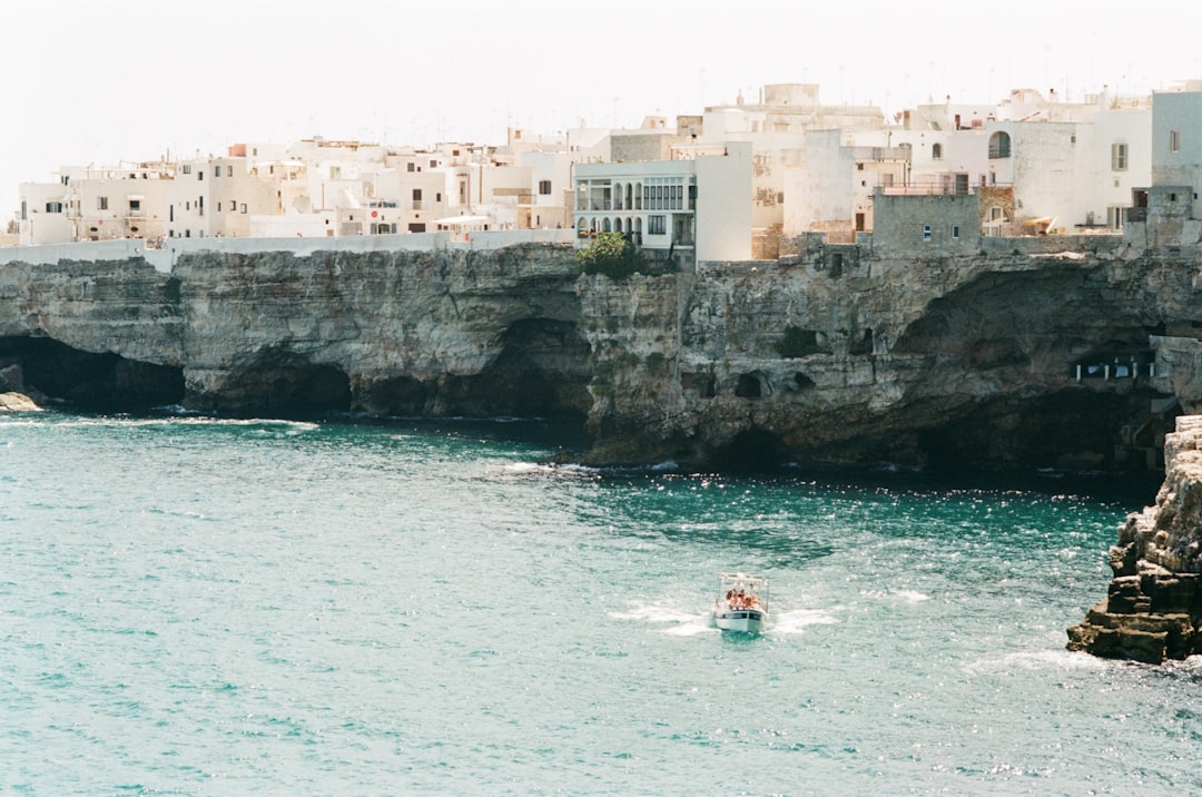 people riding on boat, //Shot on expired Kodak Gold Film</p></figure><p>While developing the film, I asked the lab to push a bit the film to give this golden hour feel to the water and to separate the white houses from the sky. They remind of Greece, don’t they? But this is the south east of Italy in the Puglia region. A part of Italy forgotten by time, and by the rest of the country…
