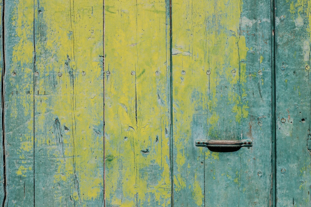 closeup photo of yellow and teal wooden board