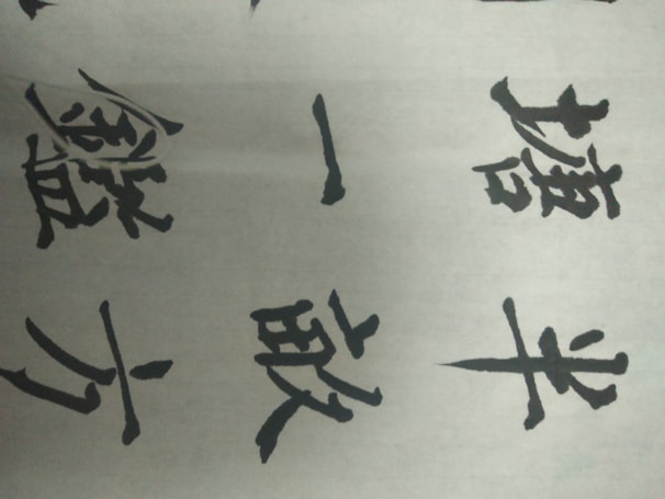 A group of professionals practicing Chinese characters together
