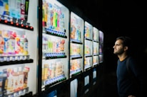 Close-up of a customer selecting CBD products from a digital touchscreen on a vending machine.