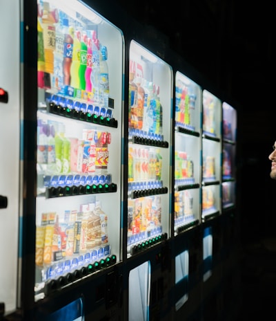 man on front of vending machines at nighttime