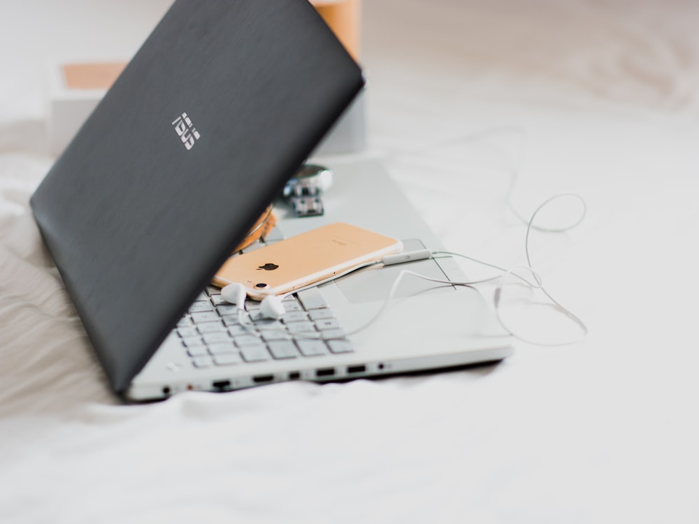 gold iPhone 6 on black Asus laptop