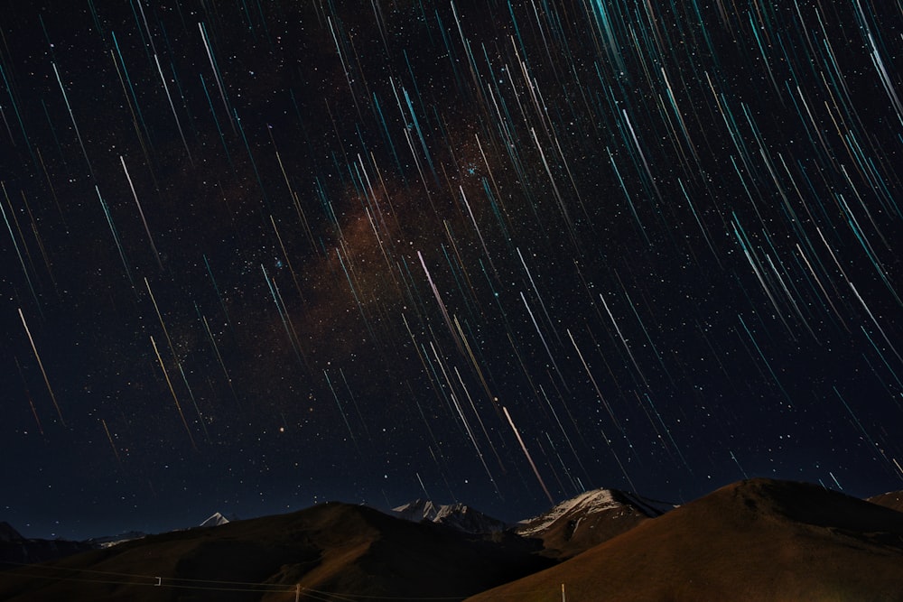 time lapse photoraphy of desert with stars