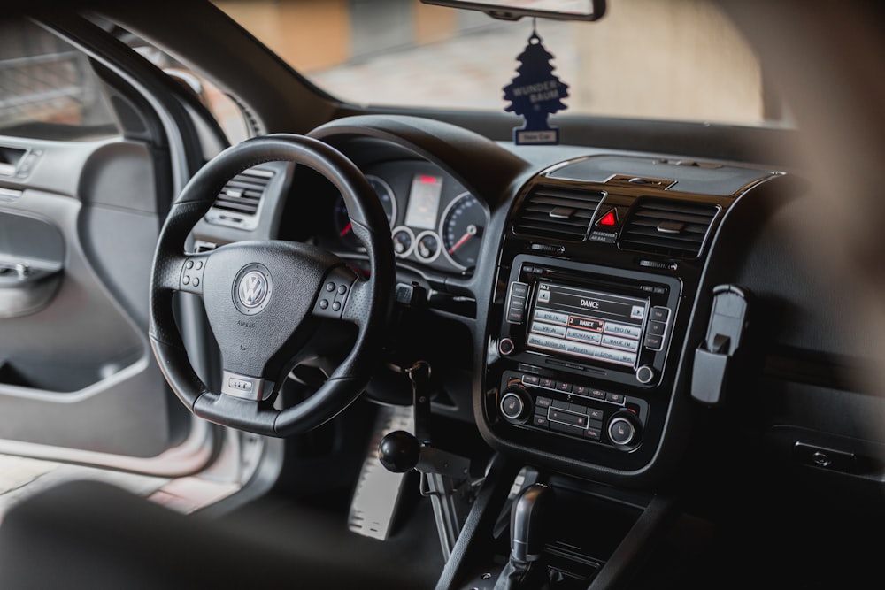 Black Volkswagen Vehicle Interior Near Brown Painted Wall Photo
