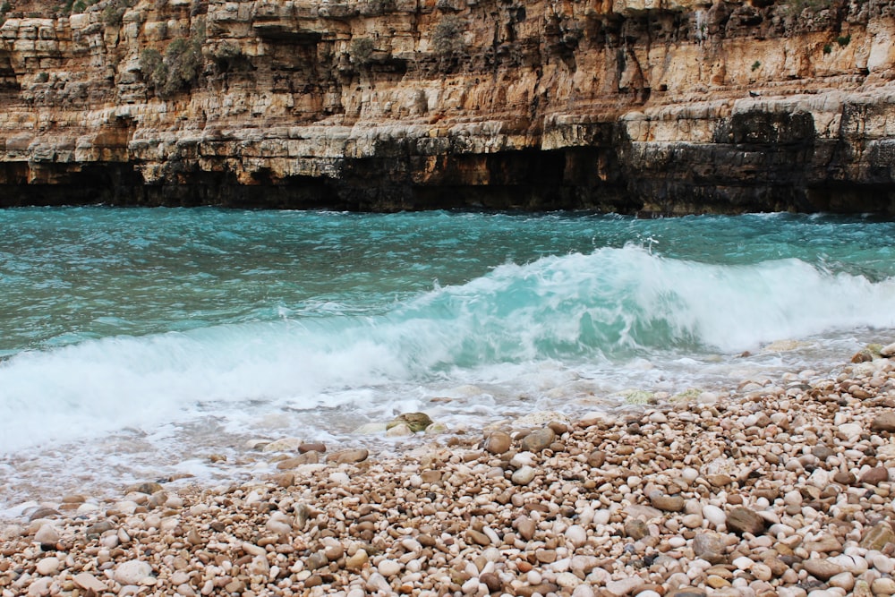 sea waves on seashore with stones