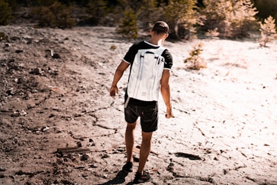 man walk on dry soil during daytime mars zoom background
