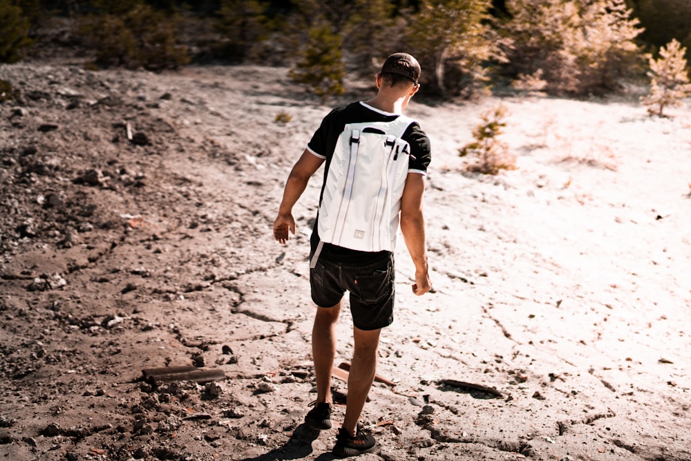 man walk on dry soil during daytime