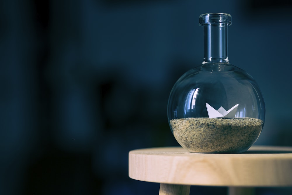 clear glass bottle on brown table