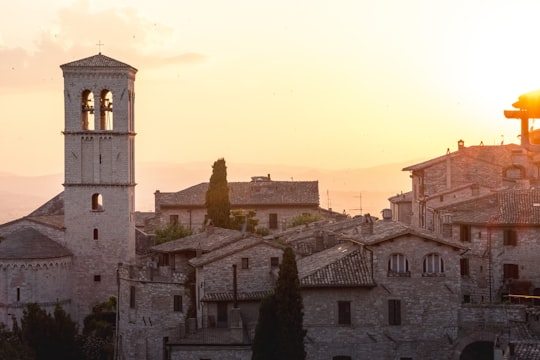 gray concrete houses and tower during golden hour in Mount Subasio Italy