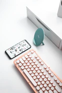 A sleek mobile cover featuring a trendy printed design, placed on a modern desk setup.