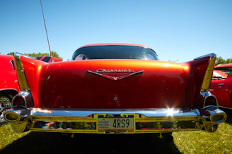 A gleaming 1948 Chevy Stylemaster Sports Coupe parked on a sunlit country road, capturing its timeless charm.